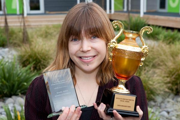 Ginette Mathis with two trophies -the one on the left is the Ambassador Trophy for first prize in the sixth New Zealand Chinese essay competition and the one on the right won for best organiser and educator in the Chinese Programme at UC.